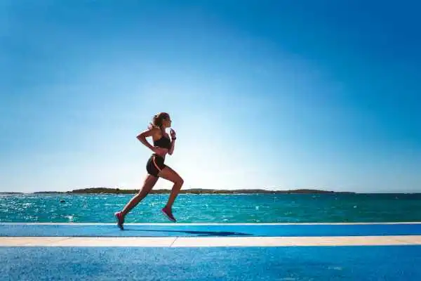 Woman running showing strong leg muscle Stoke on Trent